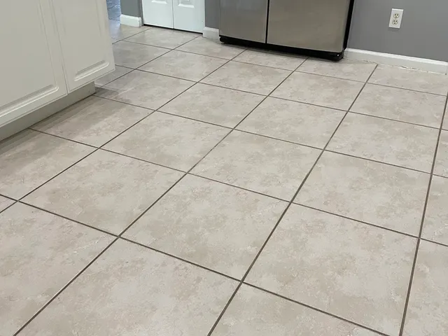 Kitchen tile floor with clean, evenly colored grout after sealing