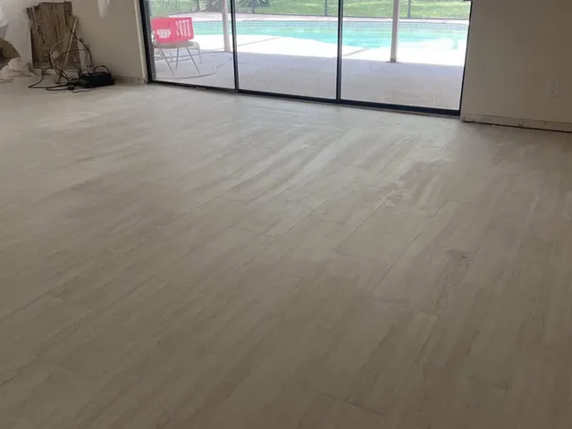 The same great room with new light wood-look porcelain plank floor installed