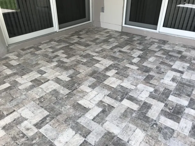 Screened lanai with new gray stone-look paver tile installed