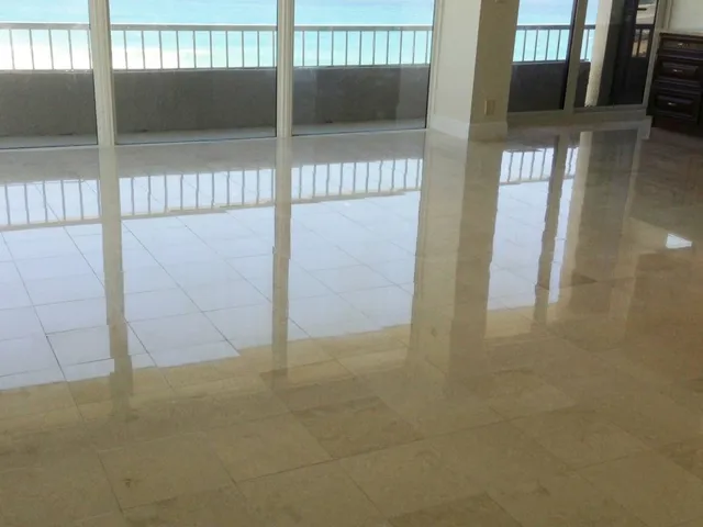 Restored beige marble floor in a condo living room with ocean view