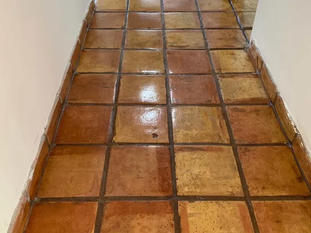 Hallway of restored Mexican tile with a warm gloss sealer