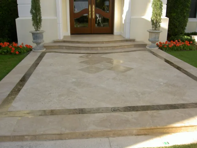 Travertine entry walkway with a color-enhancing sealer bringing out warm tones